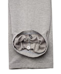 Close-up of a light gray heather sweatshirt sleeve with the cuff turned up to show a built-in drawstring pocket and white drawstring.