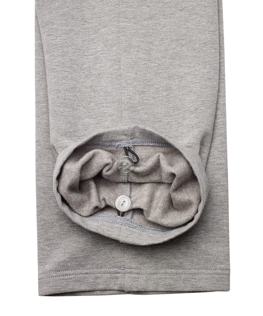 Close-up of a light gray heather sweatshirt sleeve with the cuff turned up to show a built-in drawstring pocket and white drawstring.